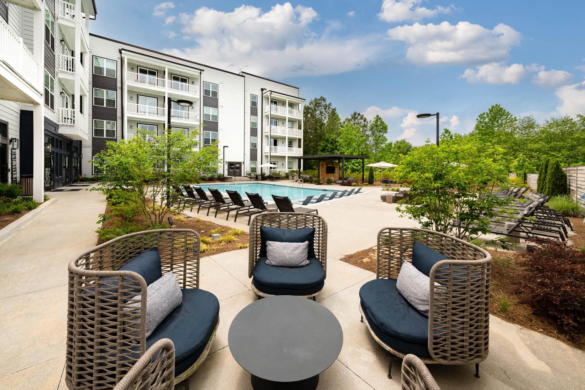 our apartments offer a pool and lounge area with chairs and tables